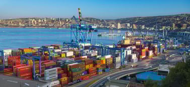 Chilean port terminal with stacked multicoloured containers signifying strategic global trade and market expansion