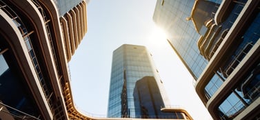 Modern Malta skyline with glass offices, symbolising business entities like Ltd, PLC, partnerships and branches in a financial hub.