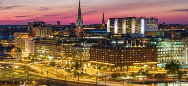 Stockholm Sweden cityscape at twilight with illuminated bridges and modern buildings signifying agile innovation and limitless global expansion